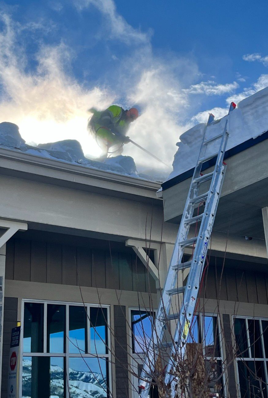Steam equipment being used to remove ice dams from a roof in Wyoming