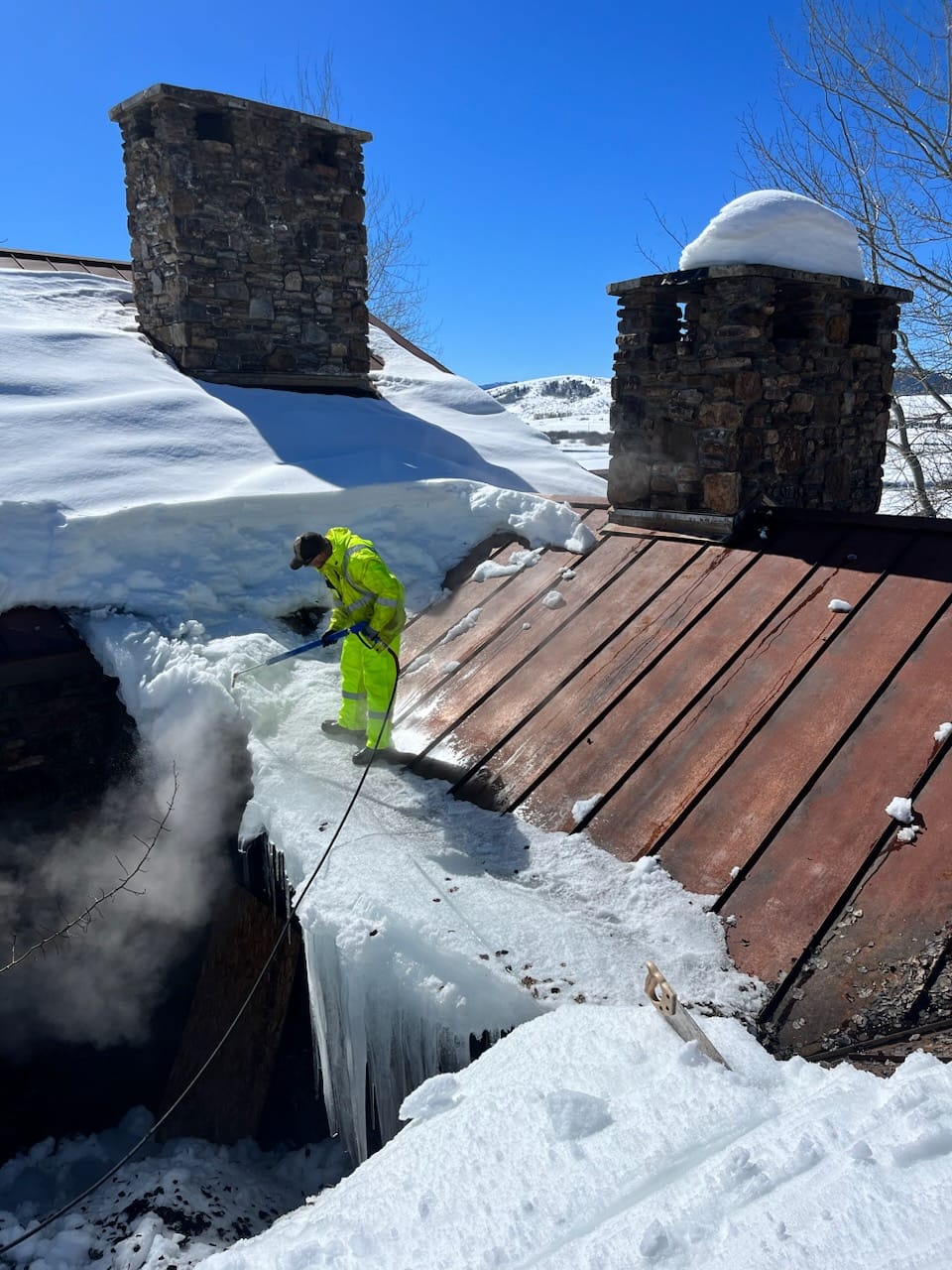 Steam equipment removing ice dam from a roof in Jackson Hole