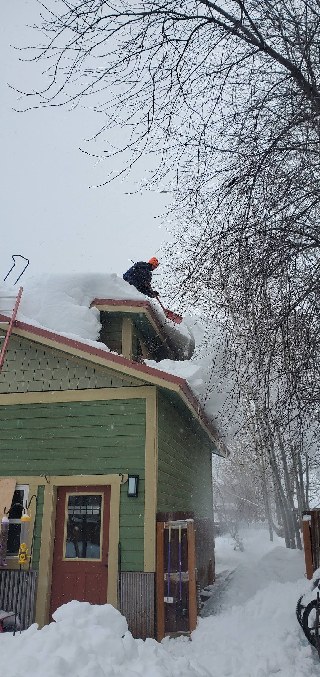Rooftop snow clearing during a snowstorm in Jackson Hole