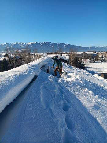 snow-removal-on-roof-with-mountain-view-jackson-hole